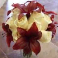 Bouquet of red and pale yellow flowers on a neutral background