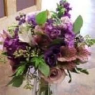 Purple and pink bouquet of flowers in a glass vase