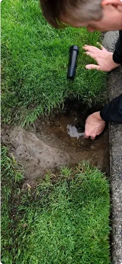 Close-up of an irrigation repair expert doing work on an irrigation system.
