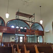 There is a scaffolding in the middle of the church.