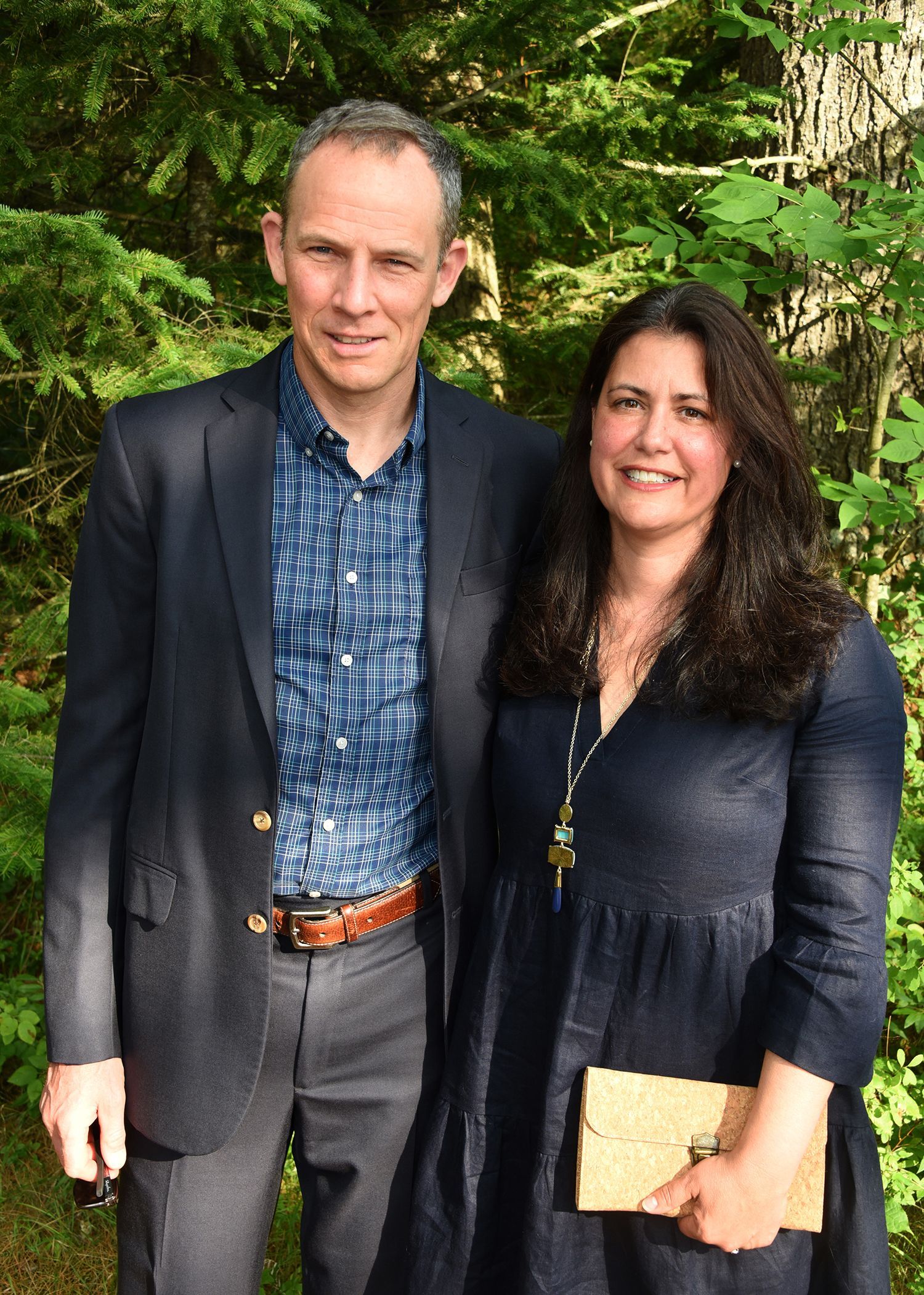 A man and woman stand together outdoors