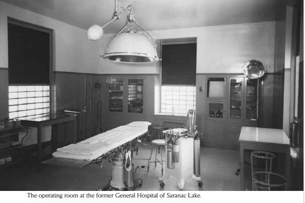 An old operating room at the former General Hospital of Saranac Lake, New York. Features an operating table, overhead light.