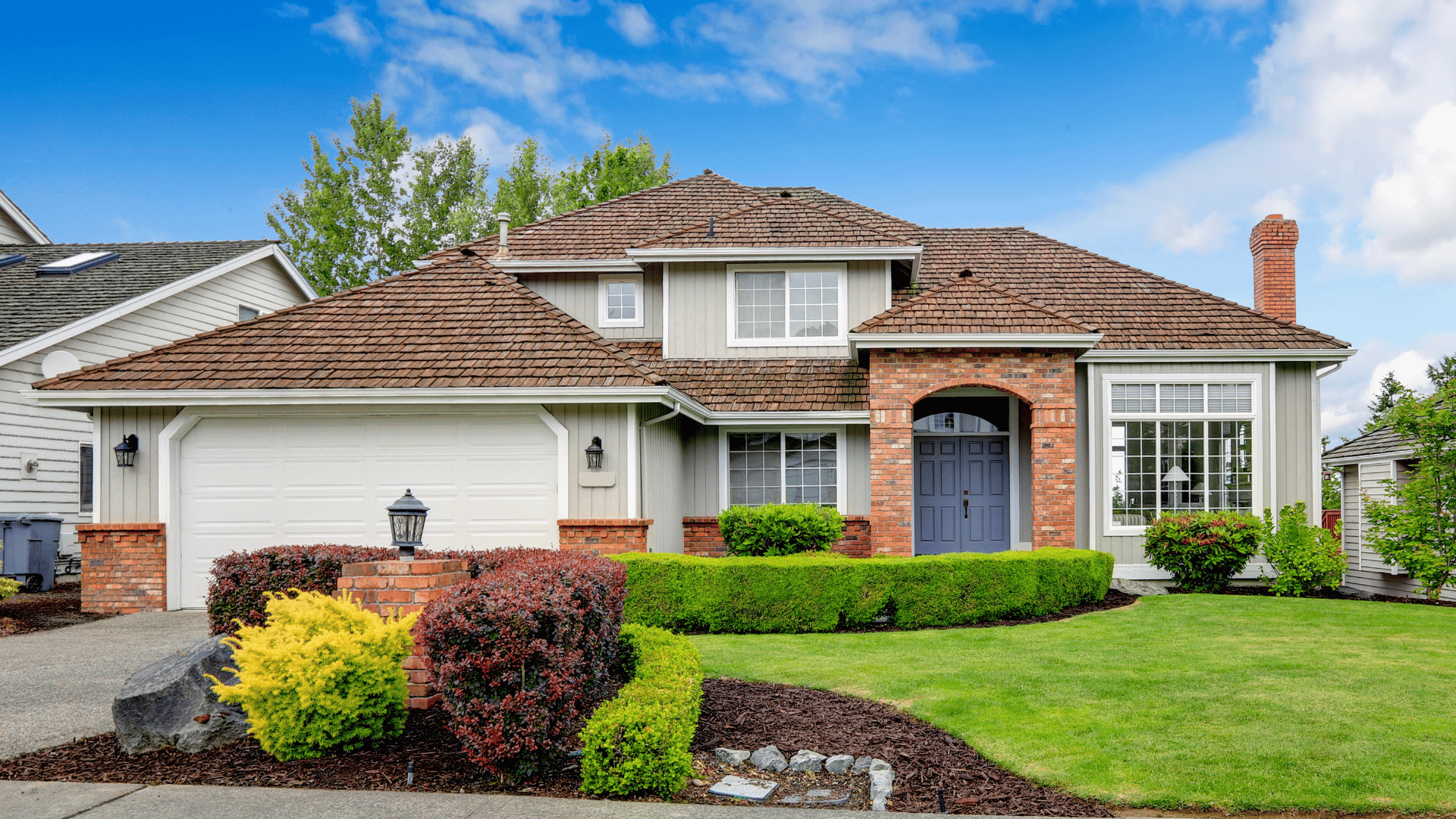 A large house with a large lawn in front of it.