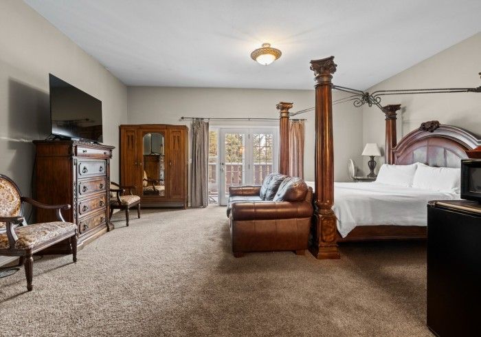 There is a four poster bed in the middle of the room.