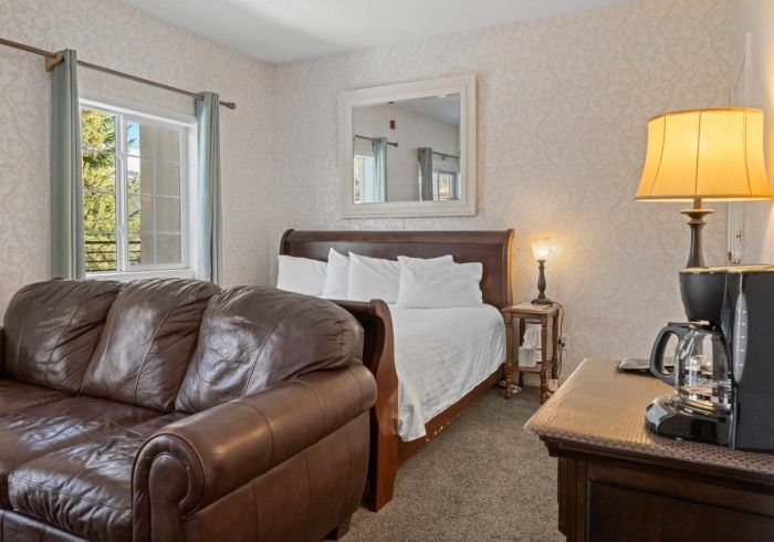 A hotel room with a couch and a bed