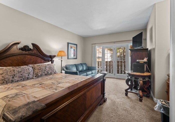 A bedroom with a king size bed and a couch