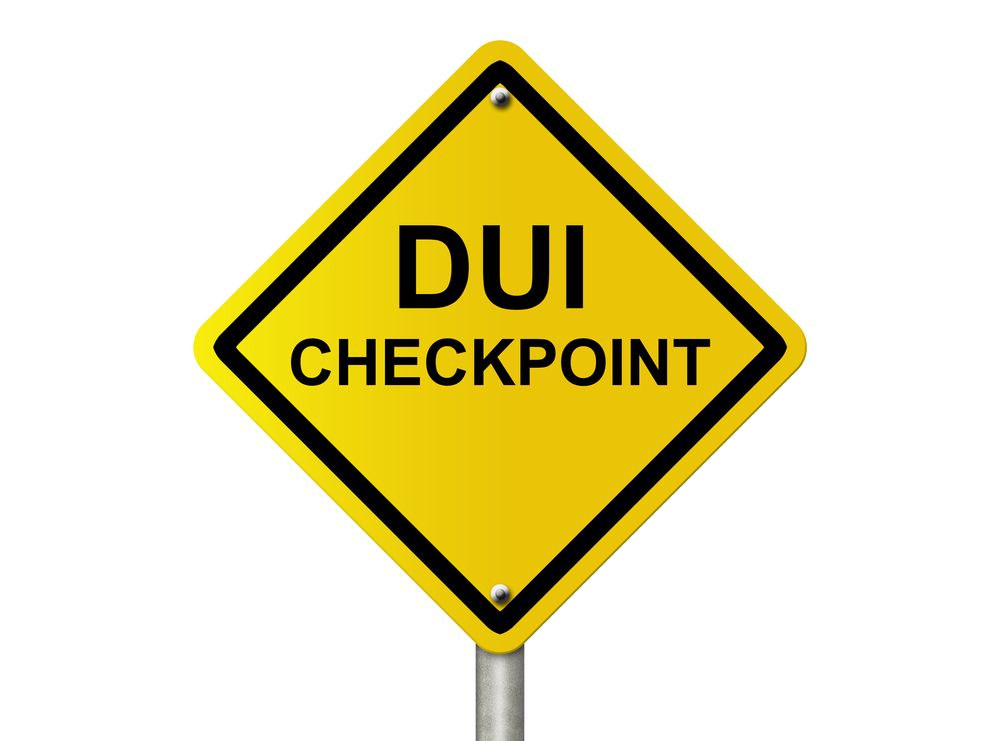 An Image of a yellow DUI checkpoint sign