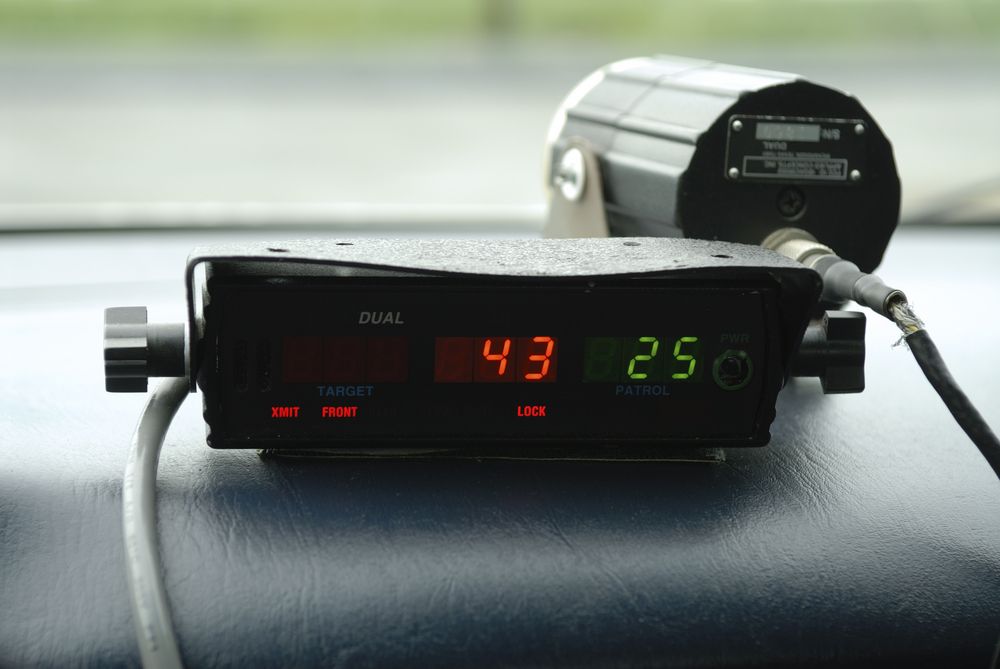 A picture of a radar gun on a dashboard with the numbers 43 and 25 visible