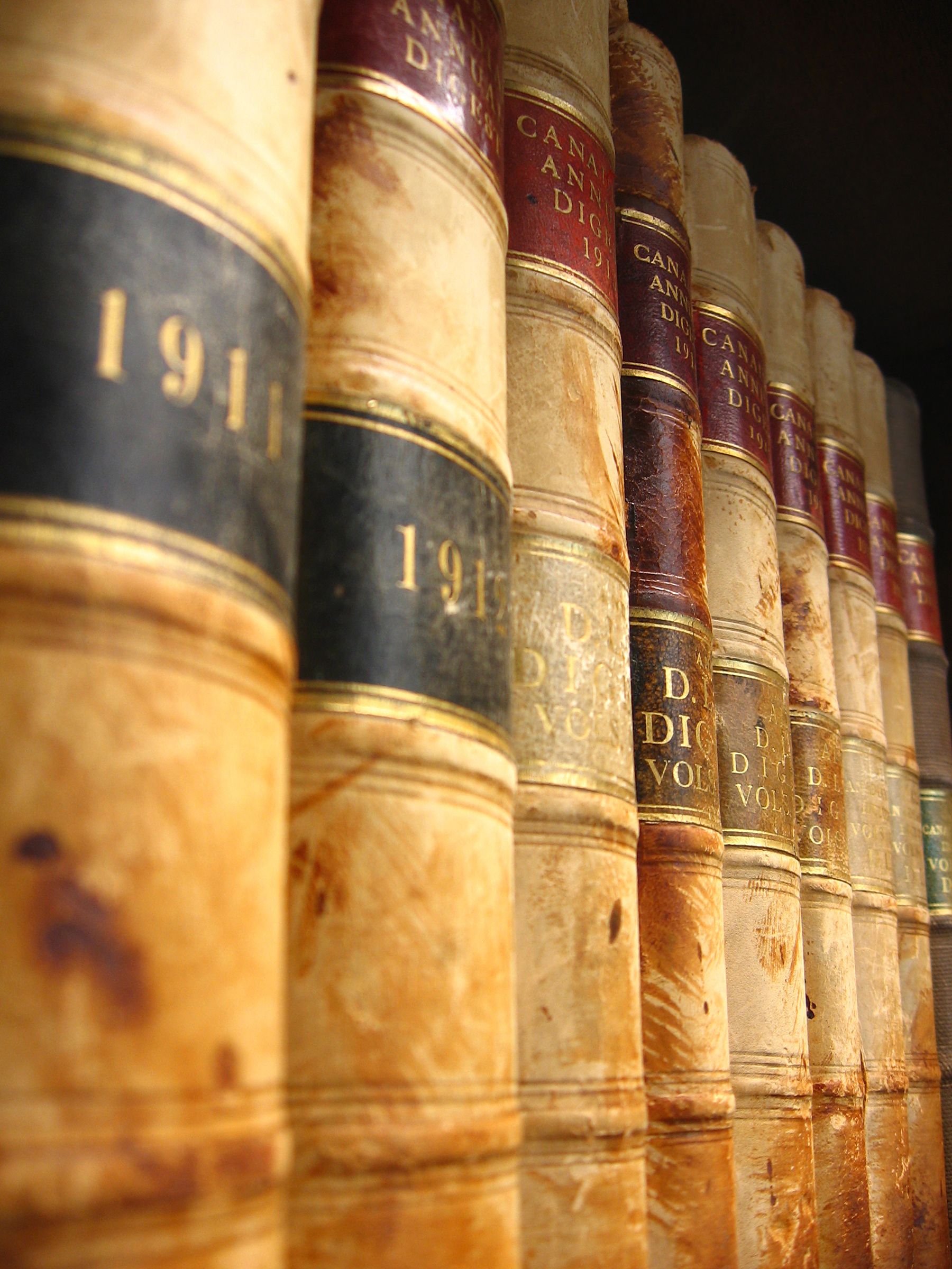 An image of a side image of 8 old law books