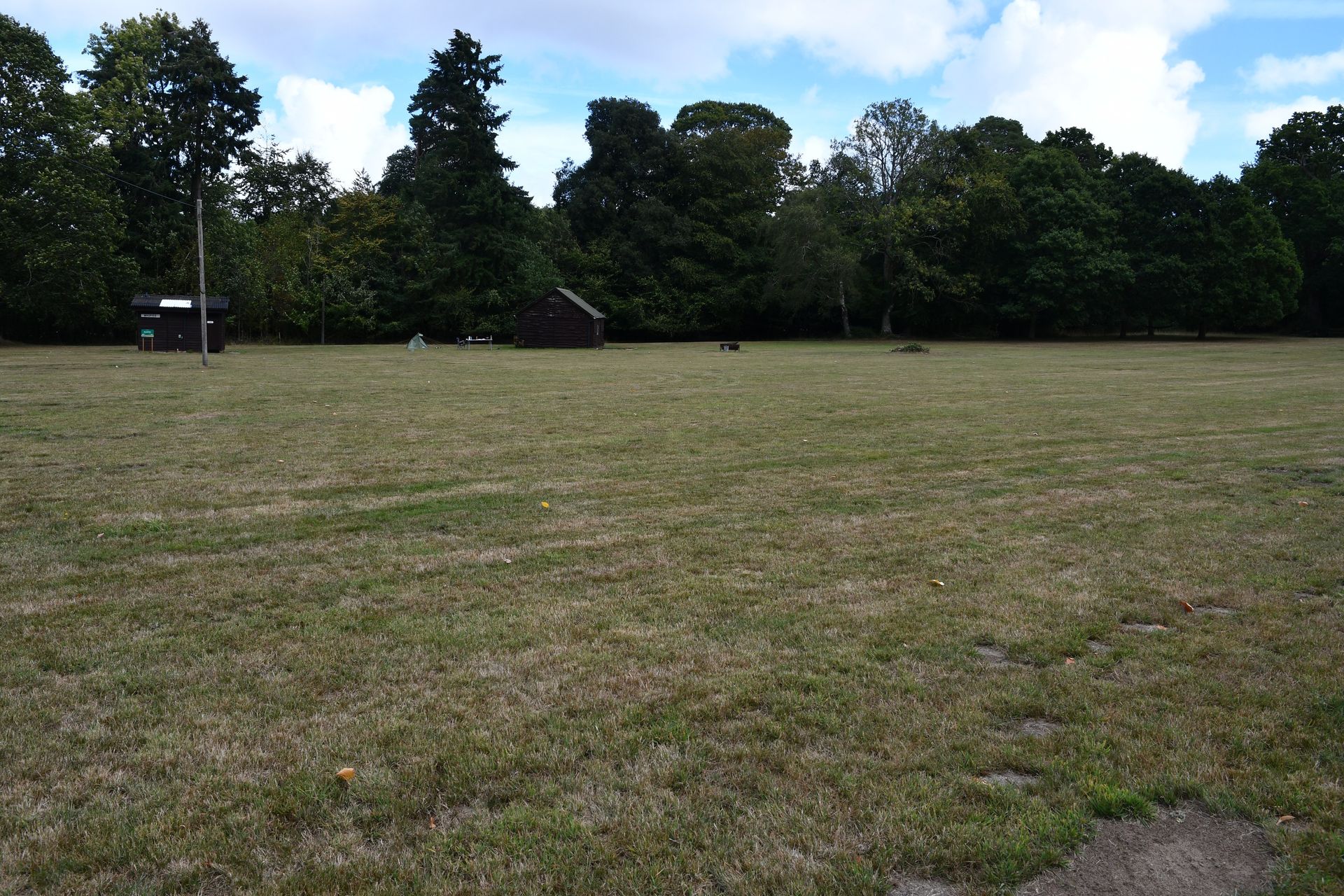 Campsite field with toilet block and shelter