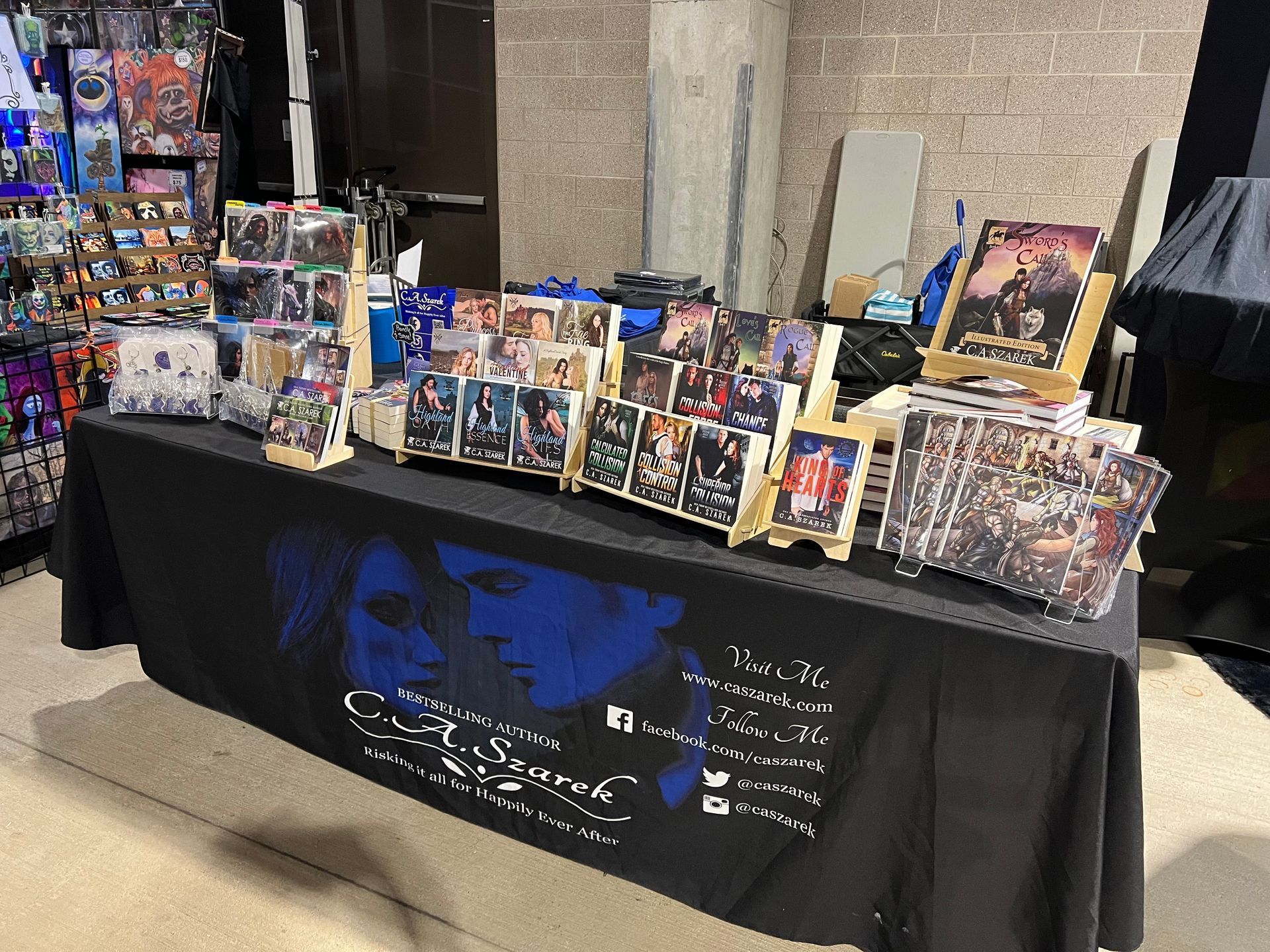 C.A. Szarek table at a signing event, table and books