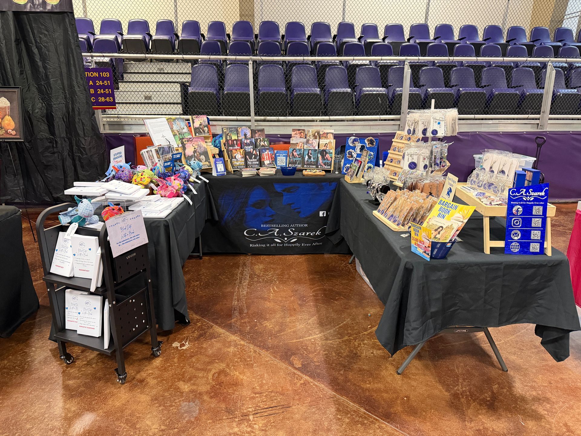 C.A. Szarek table at a signing event, table and books