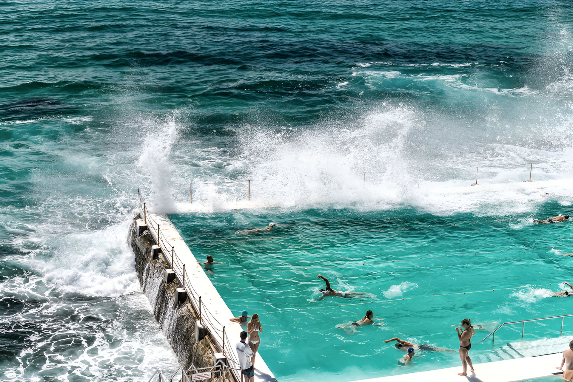 Ocean Waves Crashing Over the Edge of a Turquoise Ocean Pool — Affordable Underpinning Solutions In Bondi, NSW