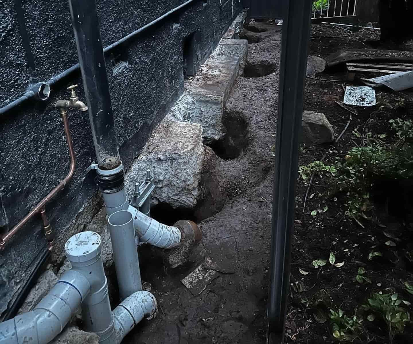 Holes around a house for underpinning — Affordable Underpinning Solutions In Shell Cove, NSW