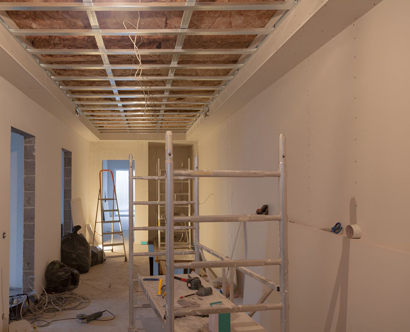 A long hallway under construction with scaffolding — Affordable Underpinning Solutions In Shellharbour, NSW