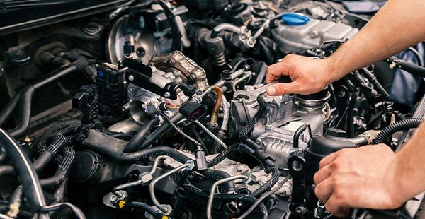 Expert staff working on engine of vehicle | Olmsted Auto Care