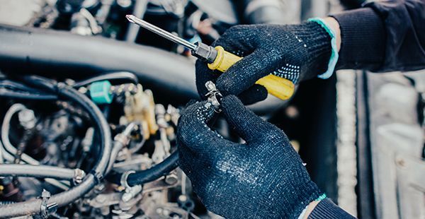 Man working on fuel system of vehicle | Olmsted Auto Care