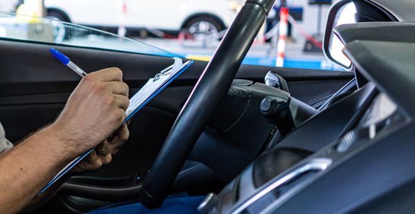 Staff member inspecting vehicle | Olmsted Auto Care