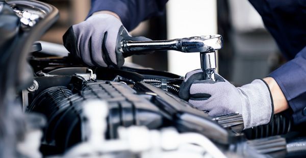 Technician working on vehicle | Olmsted Auto Care