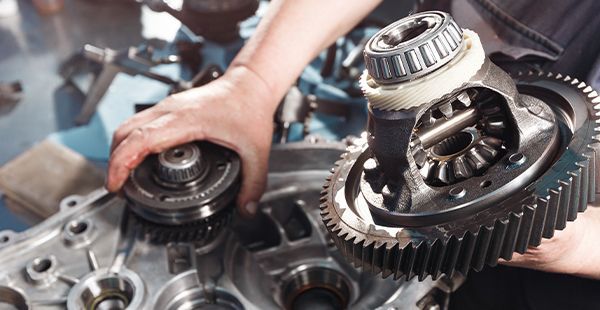 Expert staff working on transmission on vehicle | Olmsted Auto Care