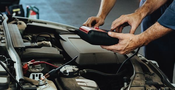 Man performing tune-up on the engine | Olmsted Auto Care