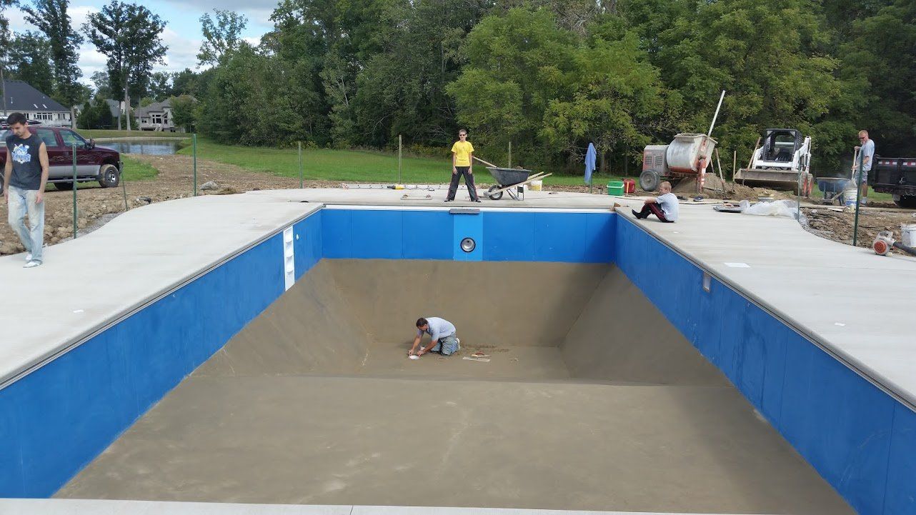 Under Construction of Swimming Pool with two Men - Pool Installation in Churubusco, IN