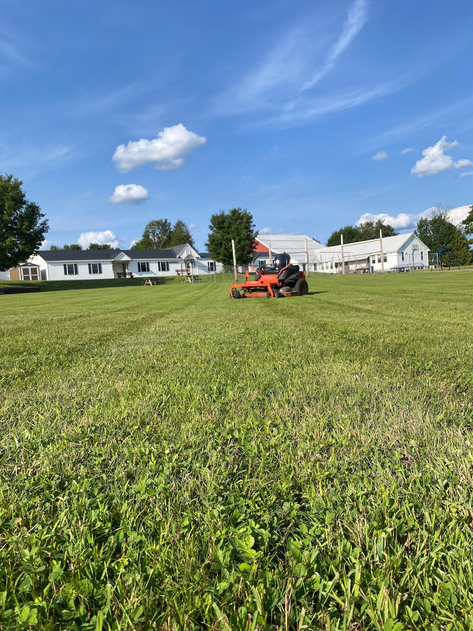 NEK Tree Workz lawn tractor parked on a recently mowed lawn by NEK Tree Workz