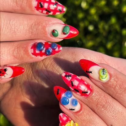 A close up of a woman 's nails with bugs on them
