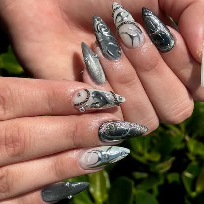 A close up of a woman 's nails with a design on them