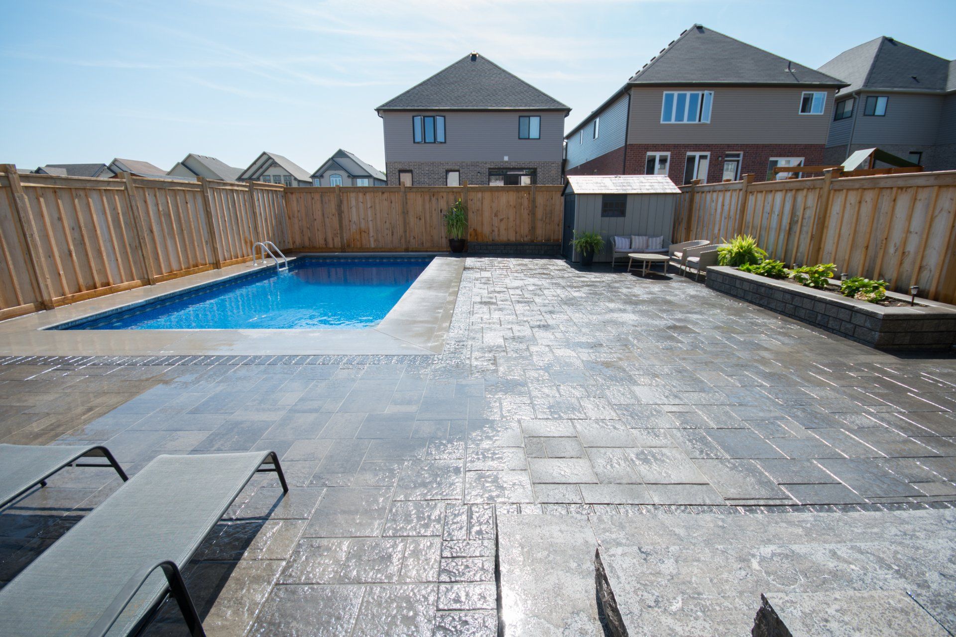 Large paved backyard with pool