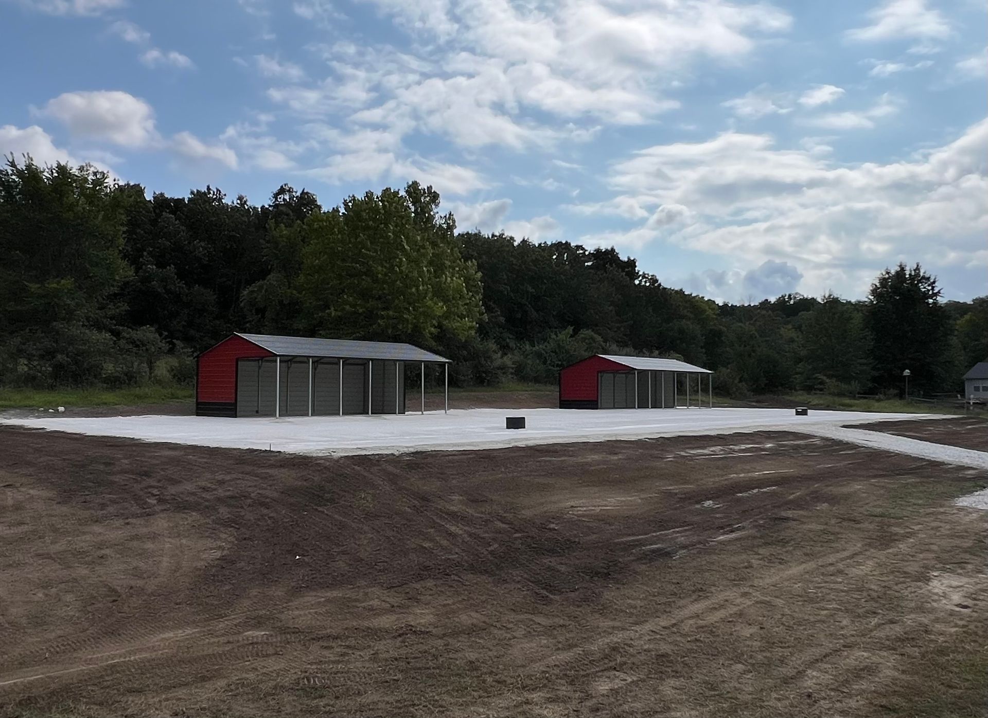 A yellow bulldozer is driving through a dirt field.