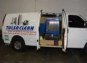 A white van with tulsa clean written on the side