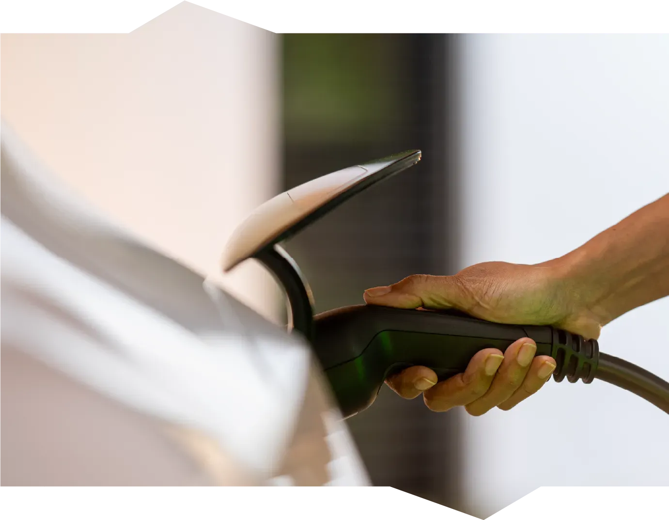 A person is opening a car door with a key.