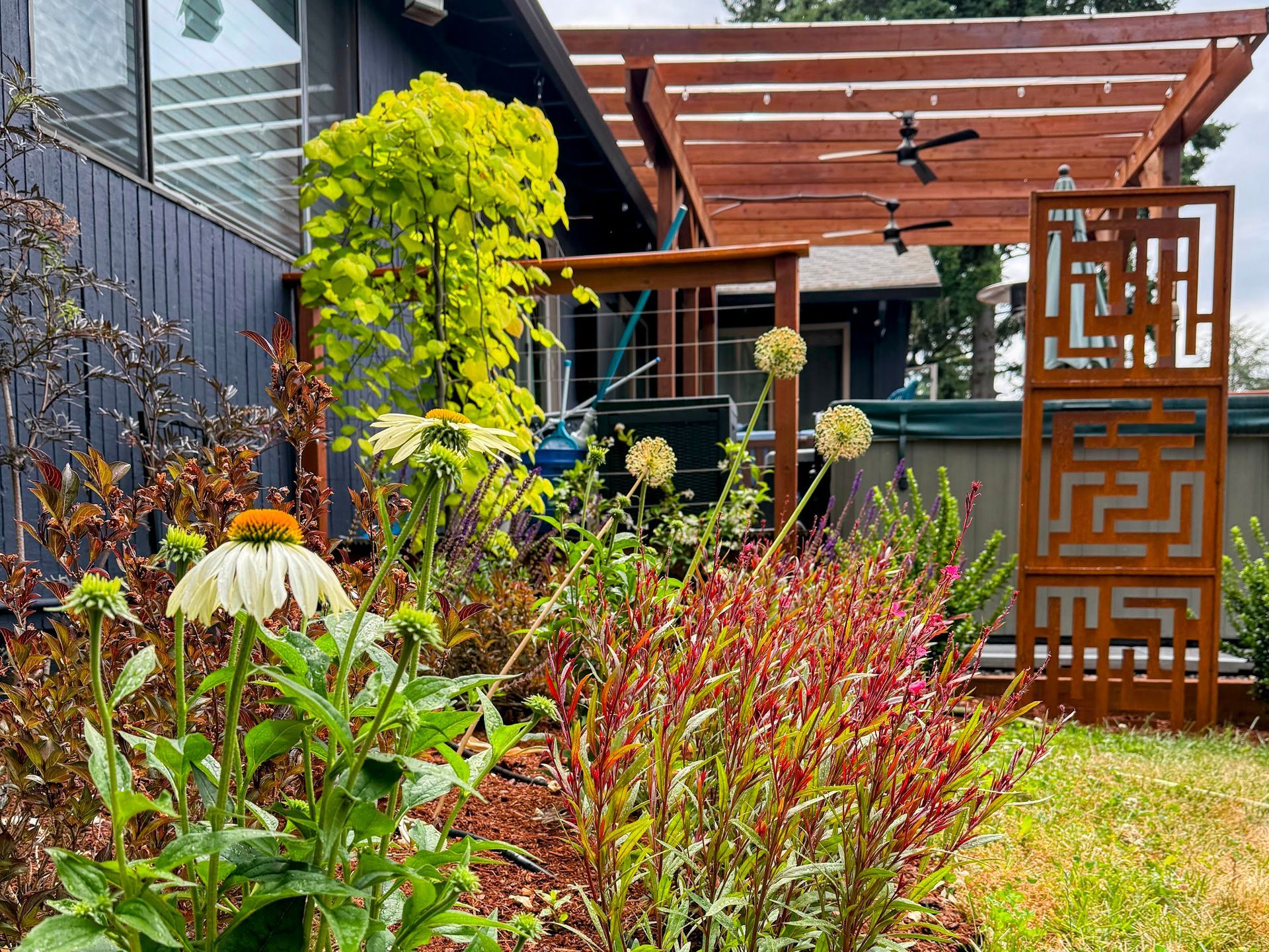 front yard raised garden beds and flagstone pathway with pollinator plants