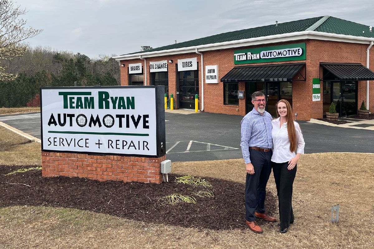 Dan Ryan and Sarah Proudly Standing outside of their new Team Ryan Location in Cumming Georgia