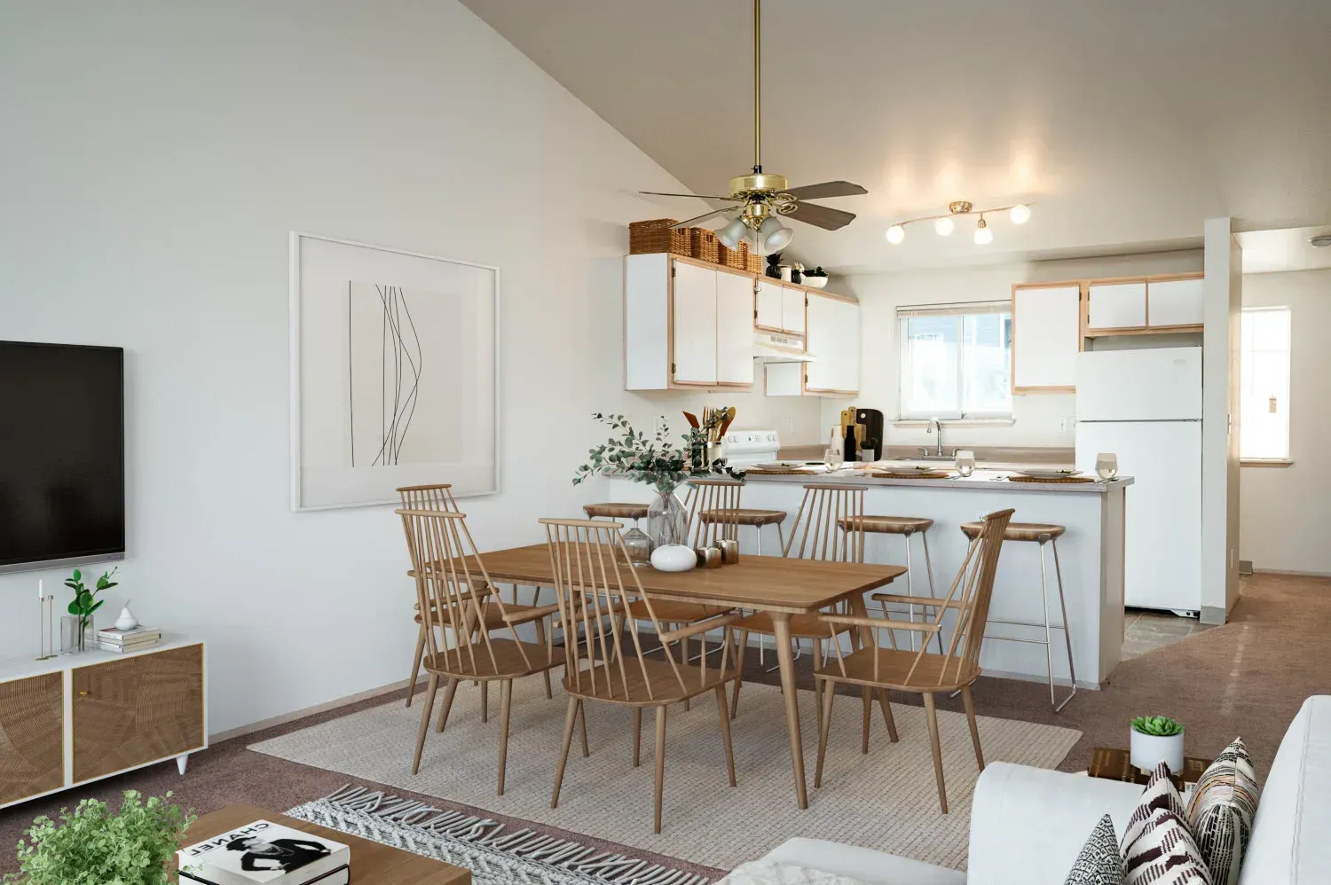 Open-concept dining/kitchen area with wooden table and chairs, white cabinets, and living room furniture.