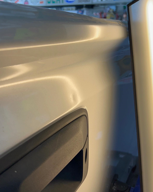 A Close Up Of A Car Door With A Dent In It – Menifee, CA – Push N Pull Paintless