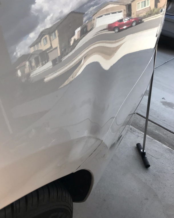 A Close Up Of A Car Door With A Dent In It – Menifee, CA – Push N Pull Paintless