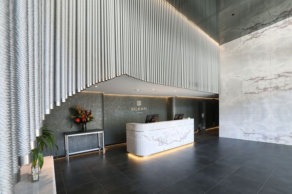 Modern Building Lobby With Marble Reception Desk and Gray Tiled Floor  — Affordable Tiles and Pavers In Morisset, NSW