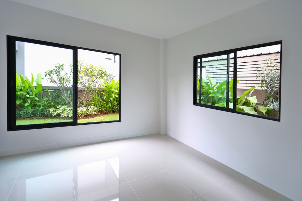 Empty Room With Two Black-framed Windows — Affordable Tiles and Pavers In Morisset, NSW