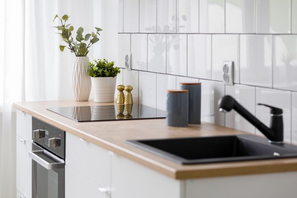 Modern Kitchen With White Cabinets, Light Wood Countertop — Affordable Tiles and Pavers In Morisset, NSW
