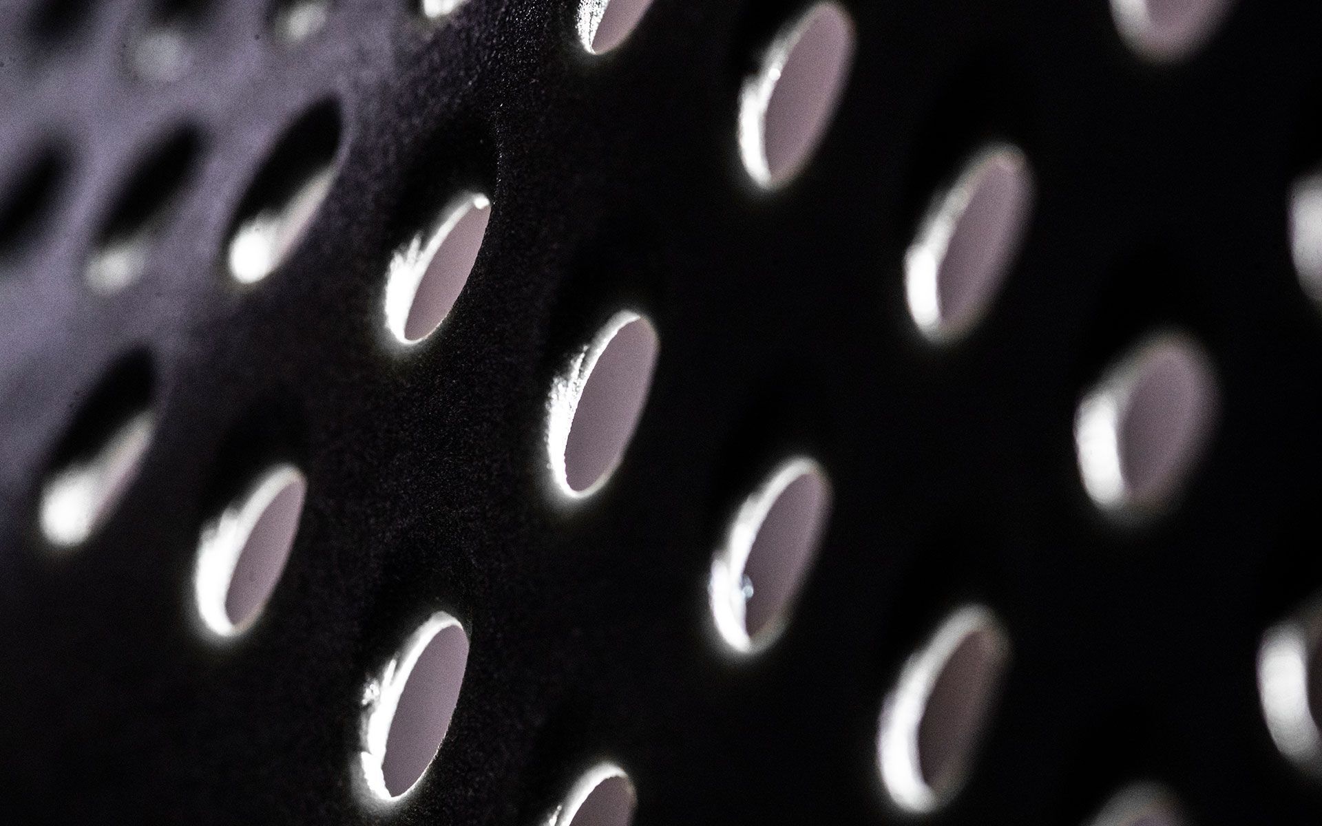 A close up of a black object with holes in it