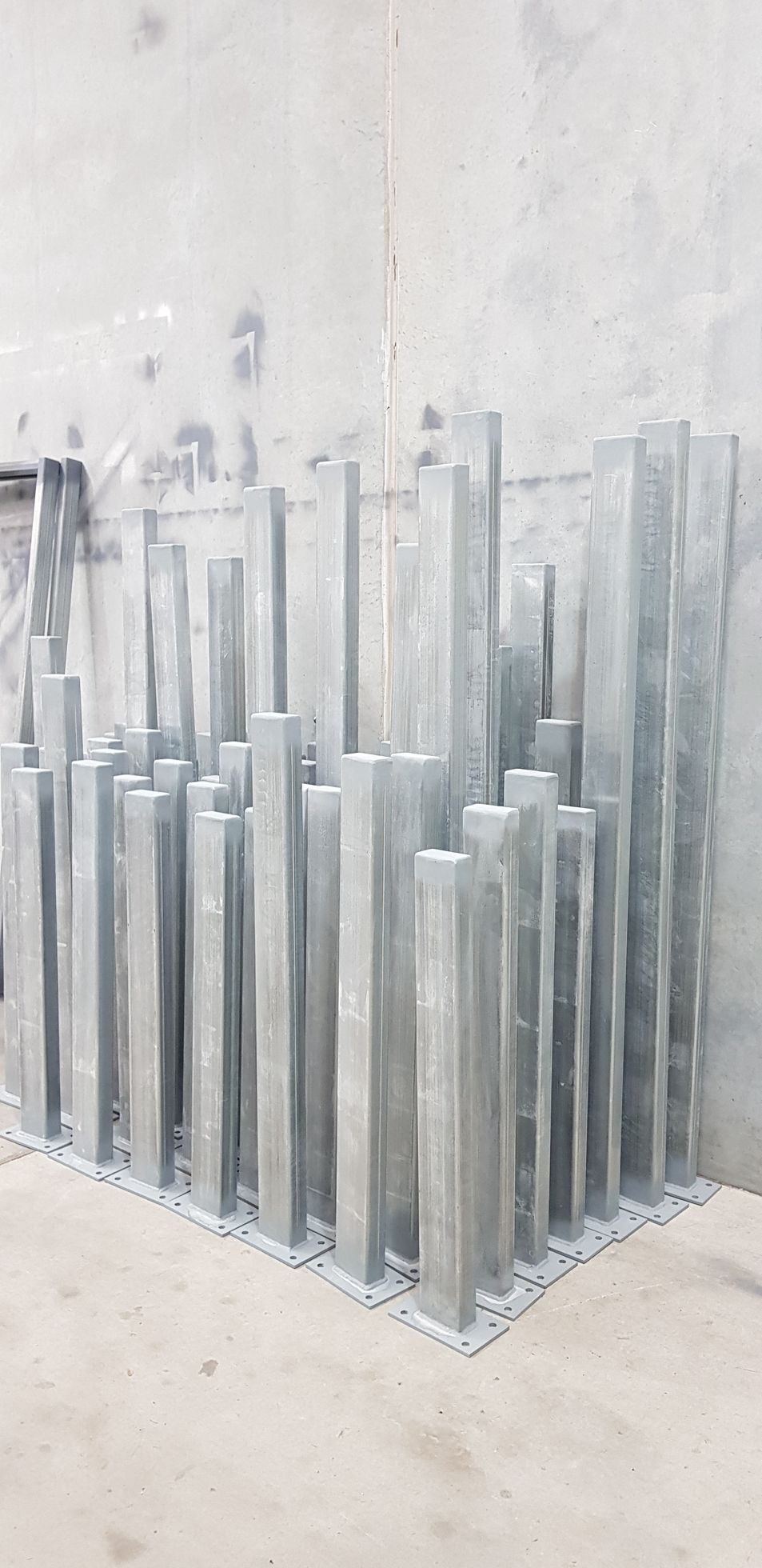 A bunch of metal poles are stacked on top of each other on a table.