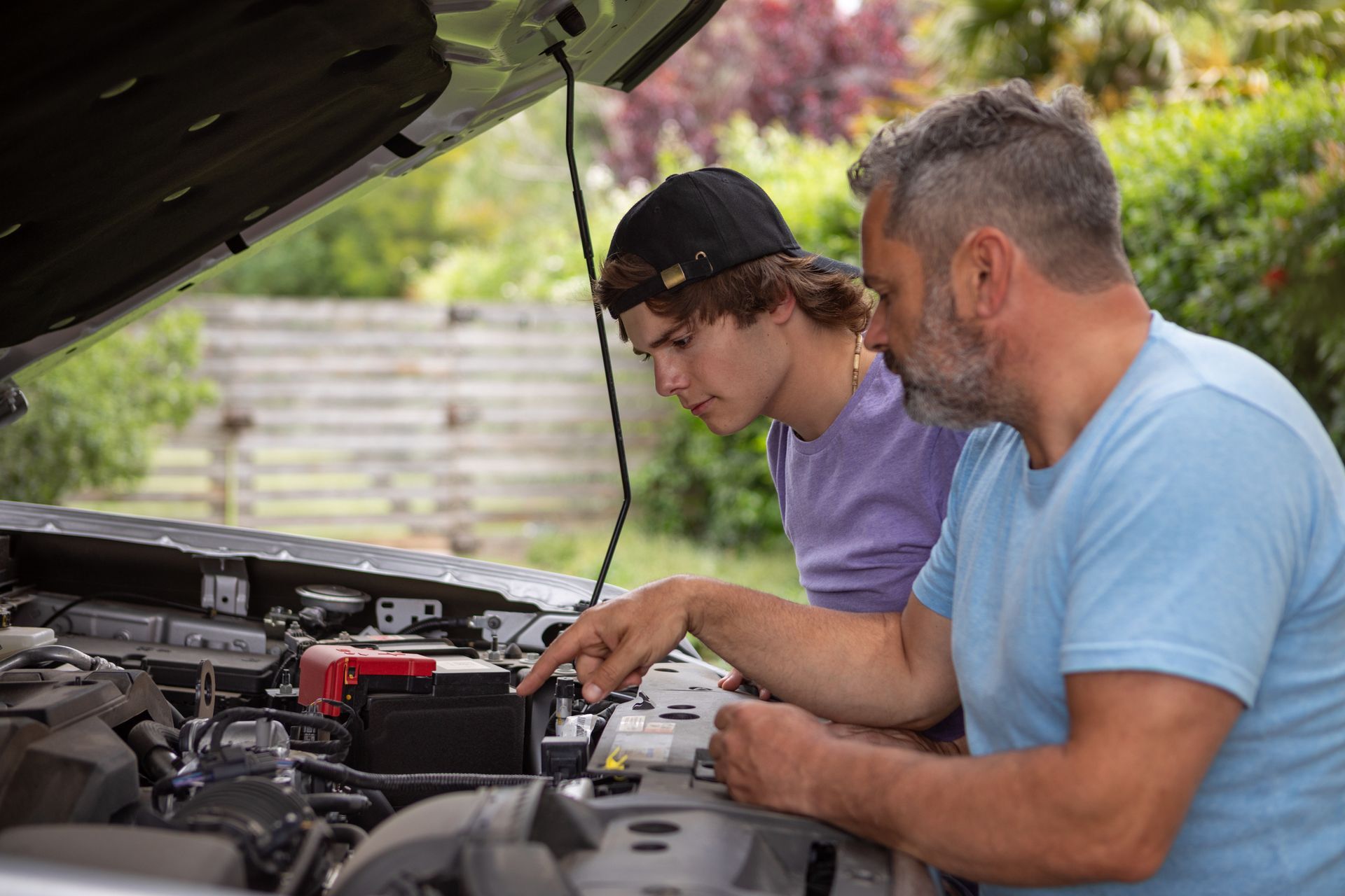 Father taught his teenage son how to repair the car. Father taught his teenage son how to repair the car.
