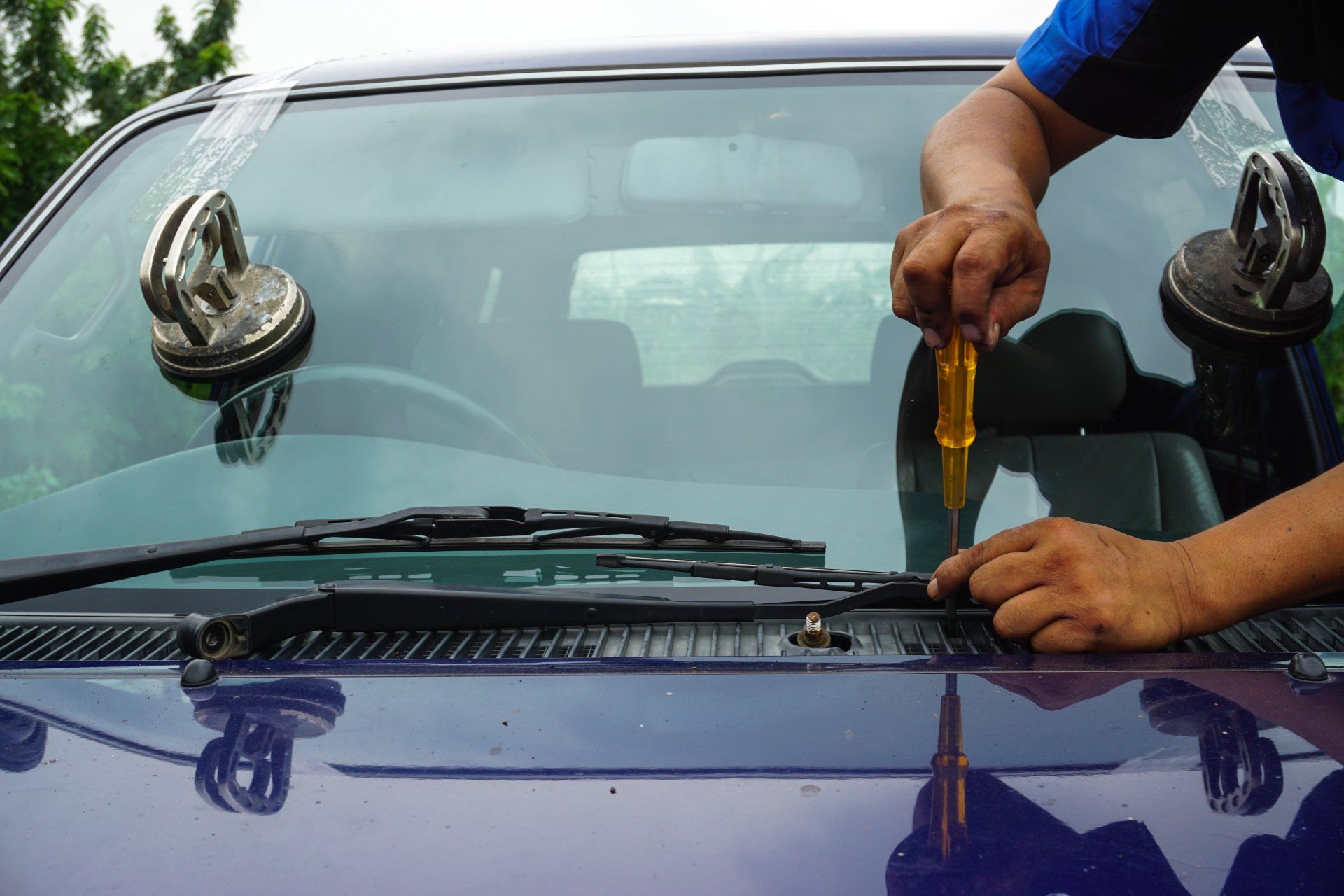 Windshield Replacement — Mechanic Fixing The Windshield In Costa Mesa, CA