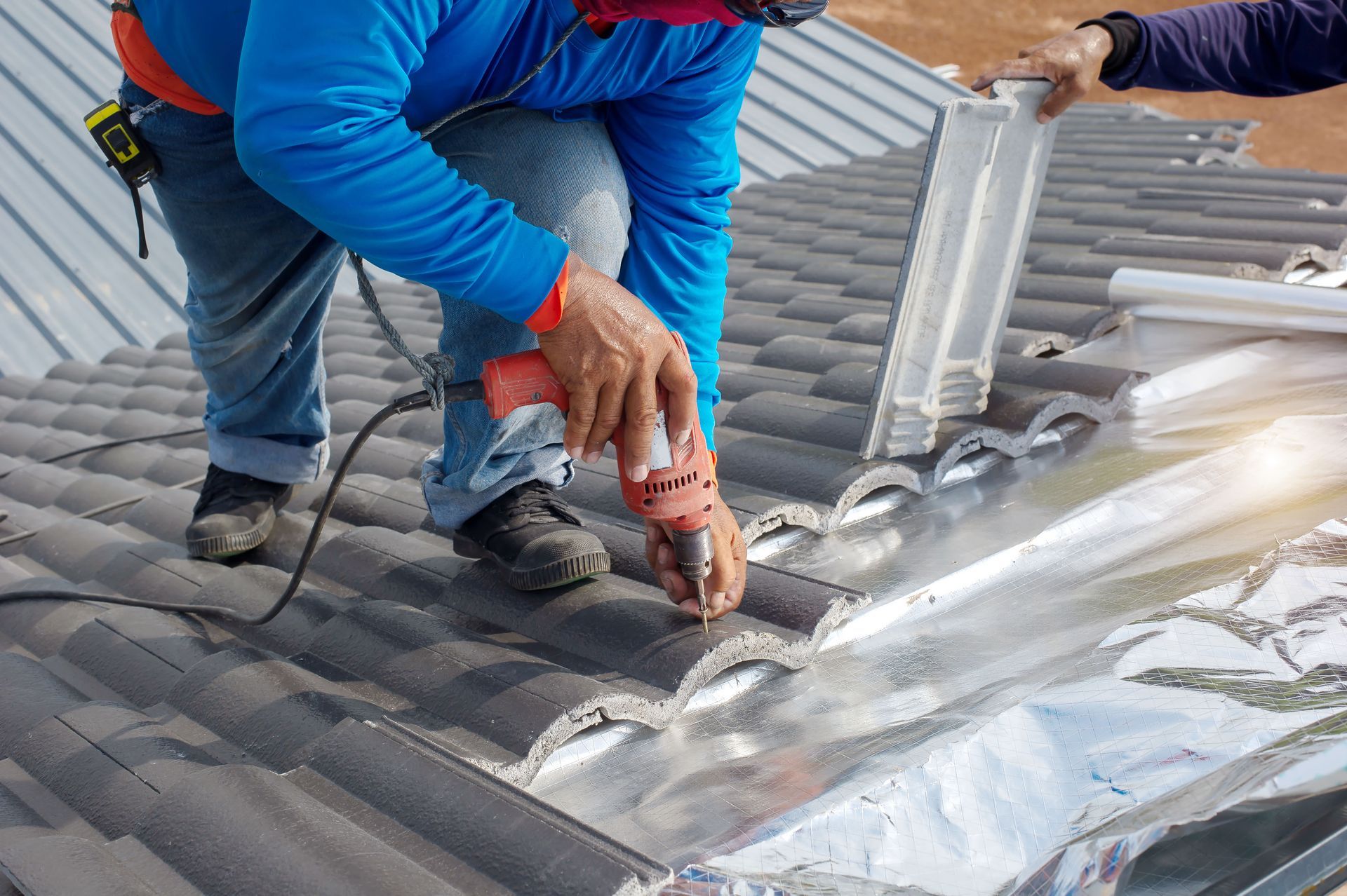  a man fixing the roof