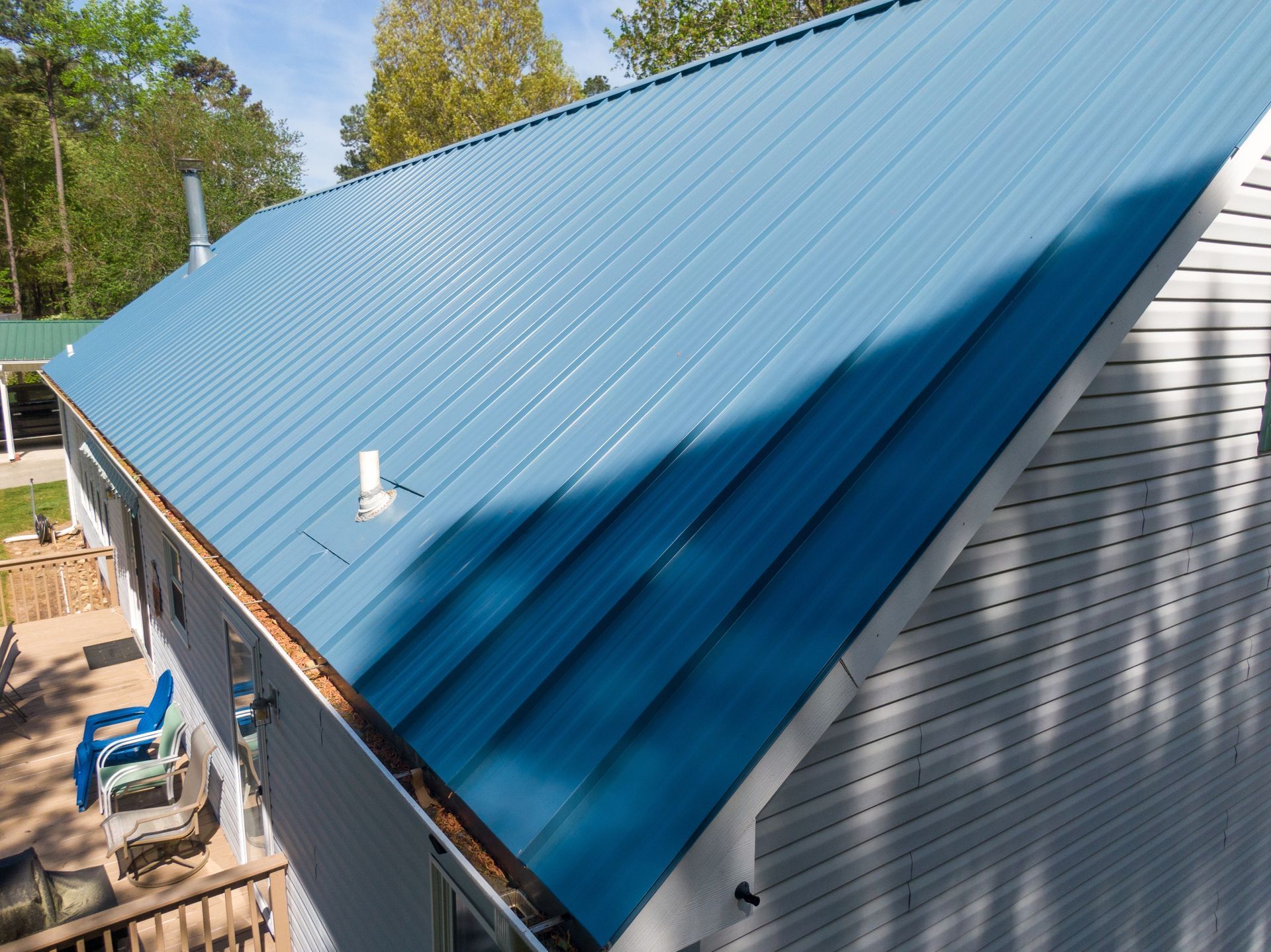 A blue roof is on the side of a house.