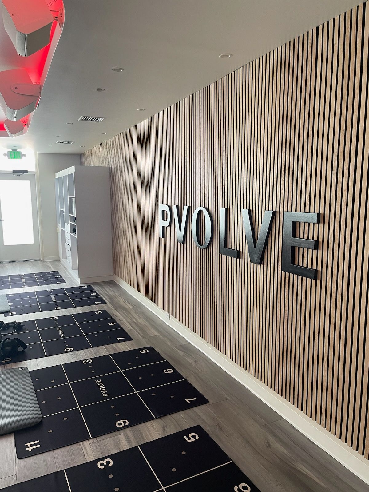 The word evolve is on the wall of a gym.