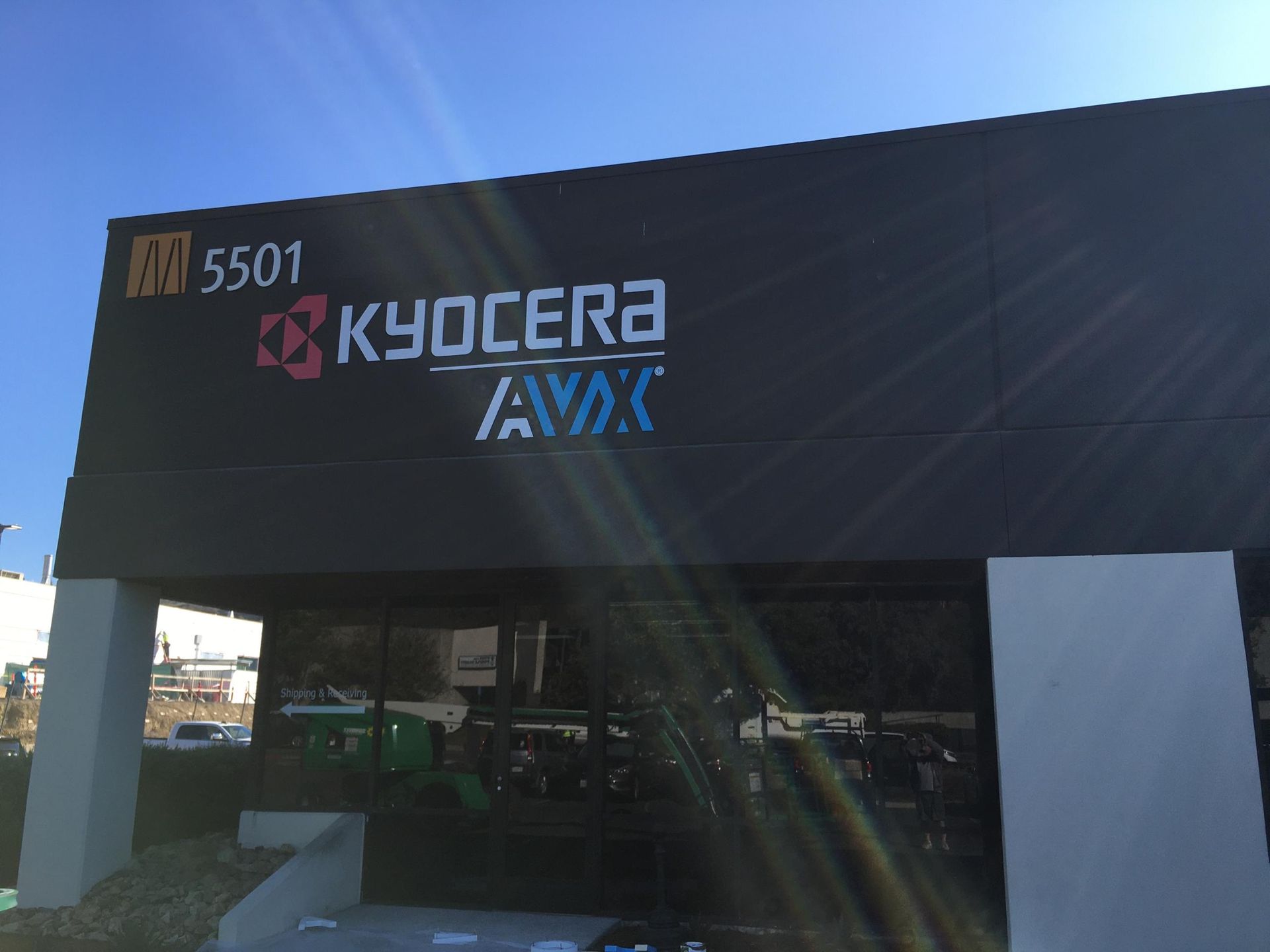 A building with a sign that says kyocera avx
