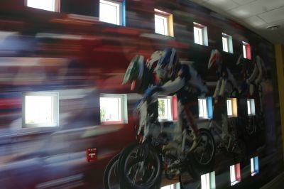 A painting of people riding motorcycles on a wall